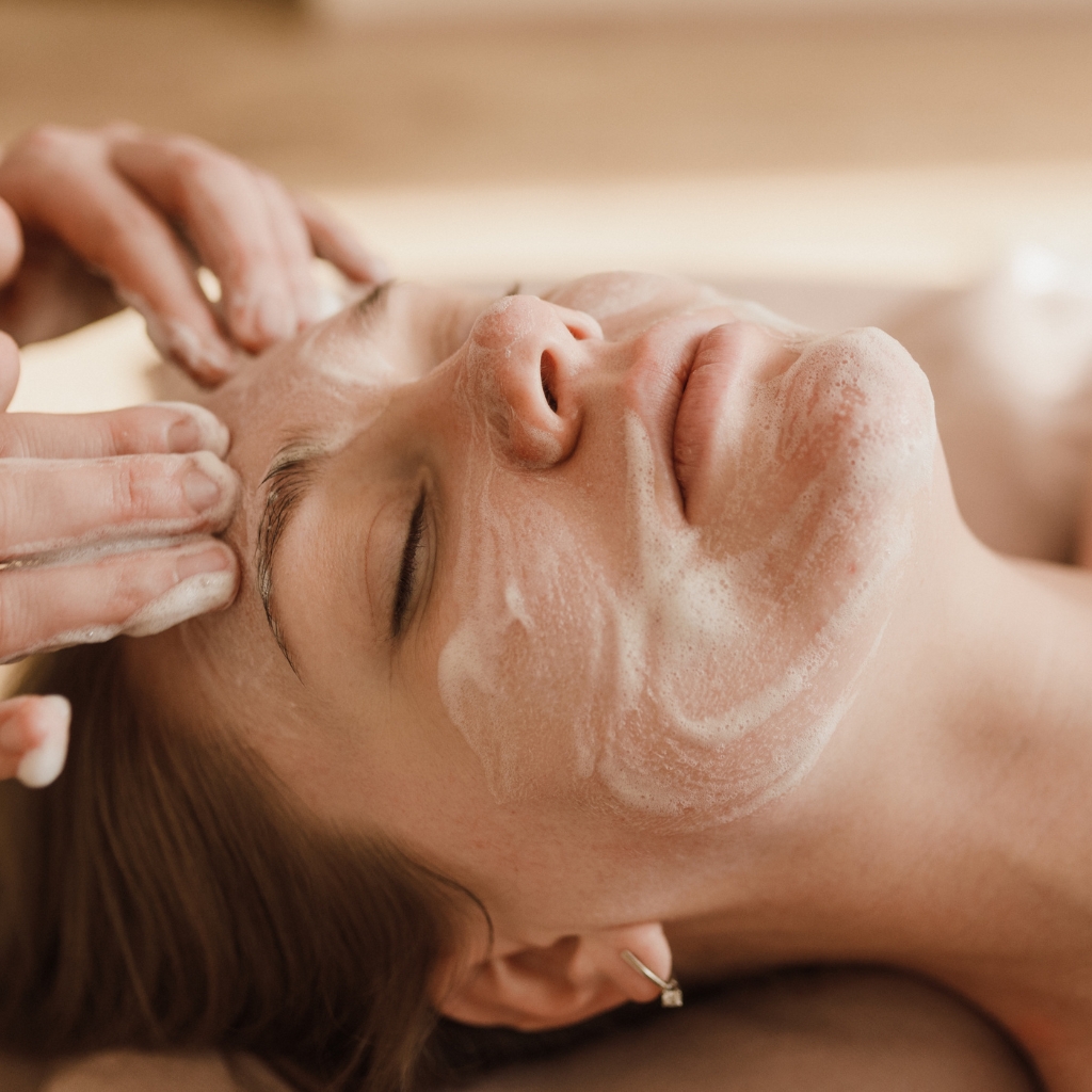 relaxed woman receiving facial